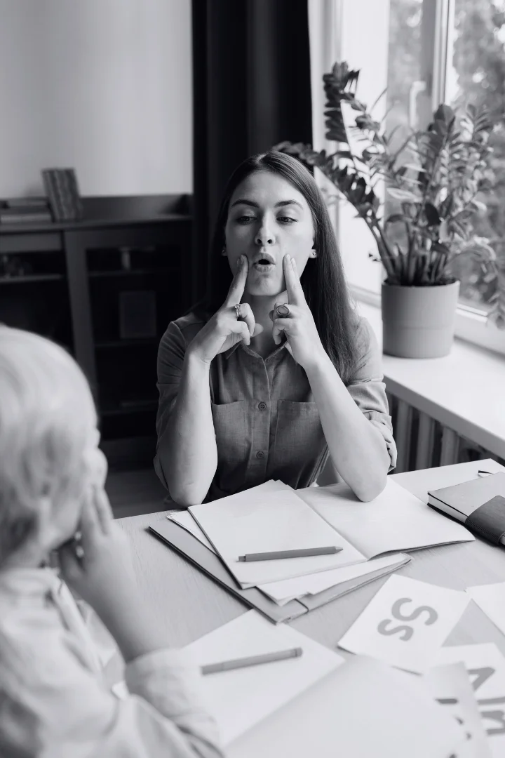 Young Woman Doing Speech Therapy With Little Boy
